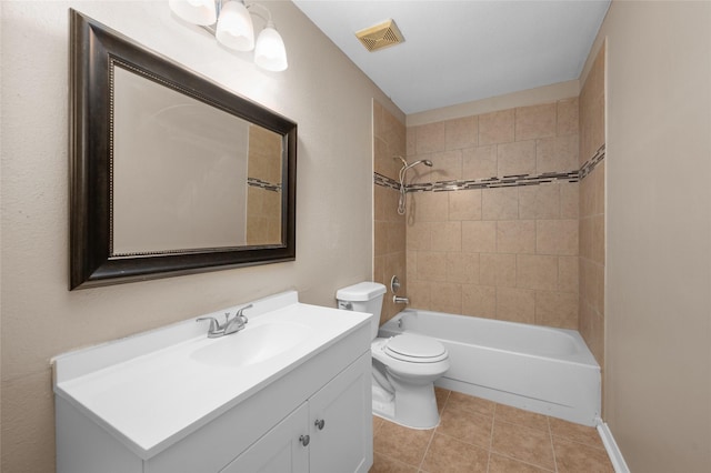 full bathroom featuring tile patterned floors, vanity, toilet, and tiled shower / bath