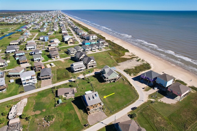 aerial view with a water view and a beach view