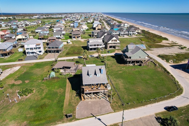 drone / aerial view with a water view and a beach view