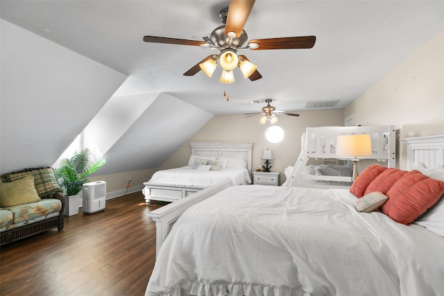 bedroom with ceiling fan, dark wood-type flooring, and vaulted ceiling