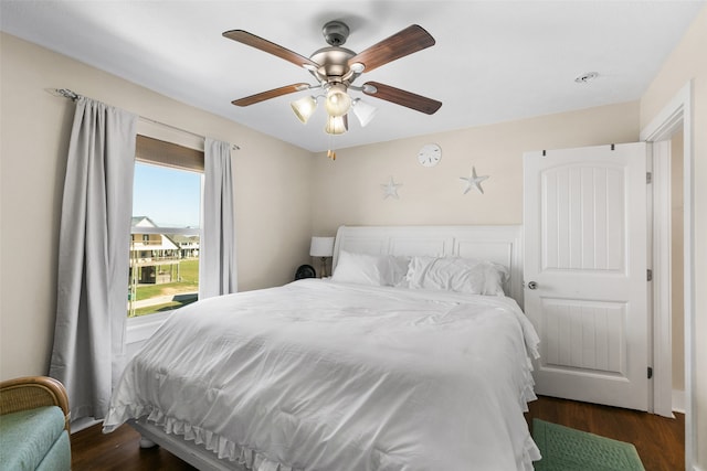 bedroom with ceiling fan and dark hardwood / wood-style flooring