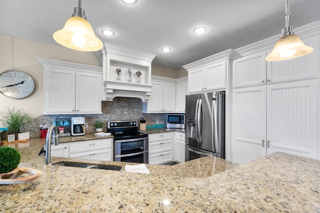 kitchen with pendant lighting, stainless steel appliances, white cabinetry, and sink