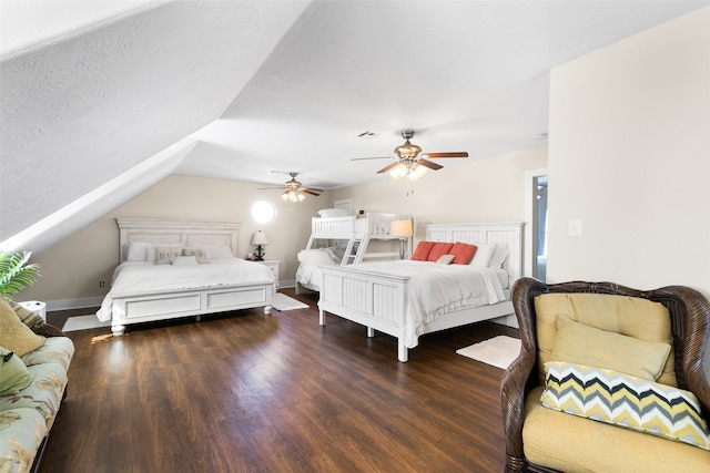 bedroom with dark hardwood / wood-style floors, ceiling fan, a textured ceiling, and vaulted ceiling