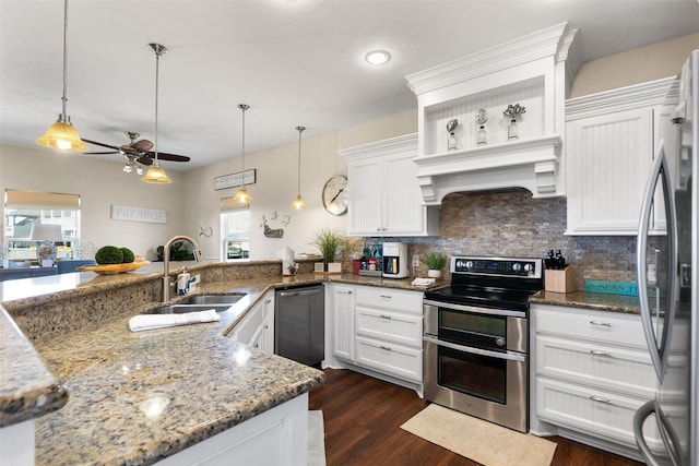 kitchen featuring decorative light fixtures, white cabinetry, sink, and appliances with stainless steel finishes