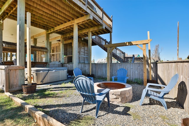 view of yard with a hot tub and a fire pit