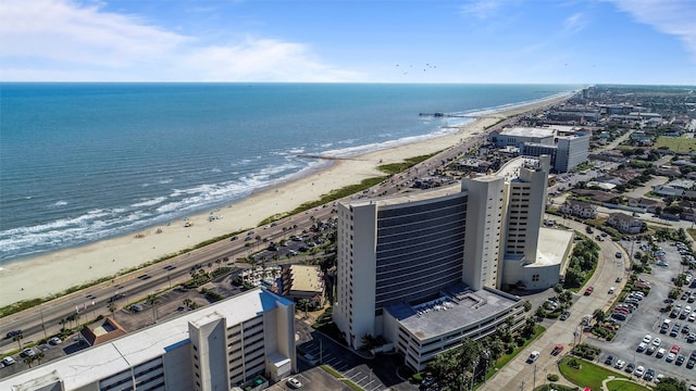 drone / aerial view with a beach view and a water view