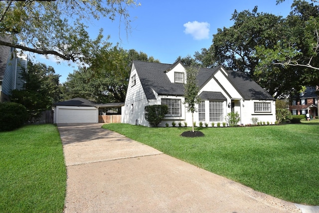 view of front of house with an outbuilding, a front yard, and a garage