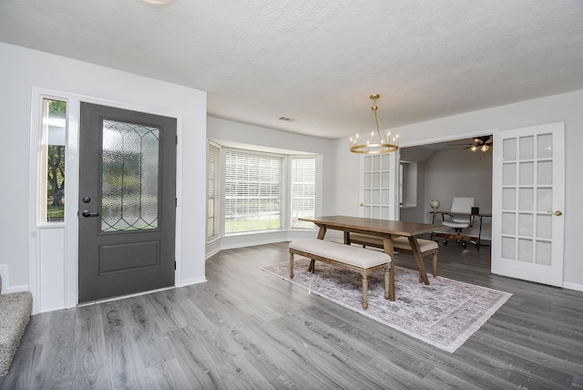 dining room with a textured ceiling, hardwood / wood-style flooring, and a wealth of natural light