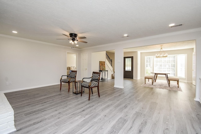 sitting room with a textured ceiling and light wood-type flooring