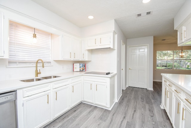 kitchen featuring white cabinetry, sink, and black electric cooktop