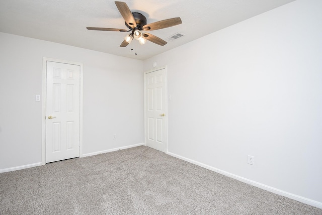 unfurnished room with ceiling fan and carpet floors