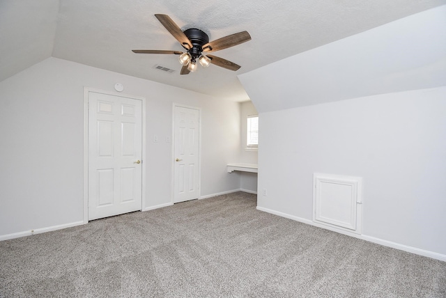 bonus room featuring ceiling fan, carpet, and lofted ceiling