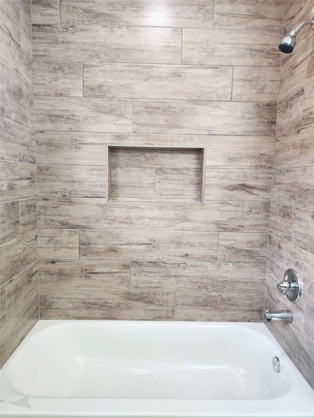 bathroom featuring tiled shower / bath