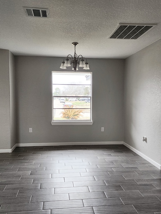 spare room with a chandelier