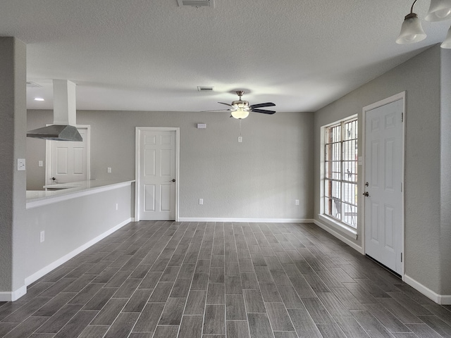 unfurnished living room featuring ceiling fan