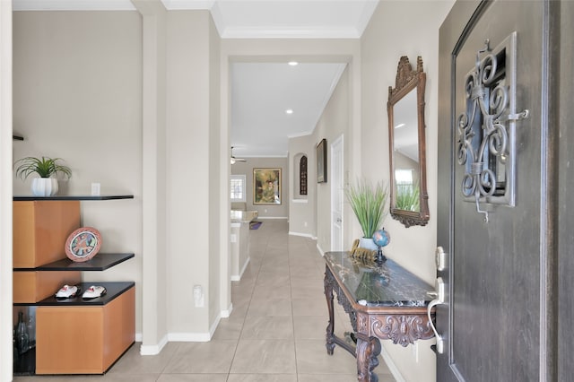 hallway featuring ornamental molding and light tile patterned floors