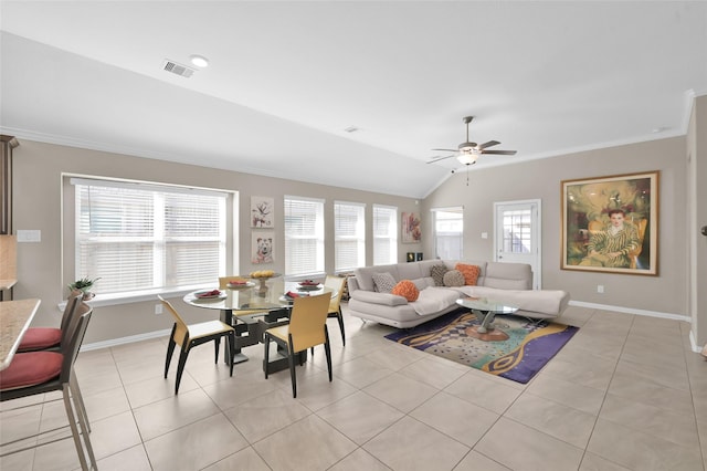 living room featuring light tile patterned flooring, ornamental molding, lofted ceiling, and ceiling fan