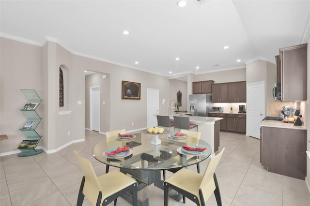 dining room with light tile patterned flooring and ornamental molding