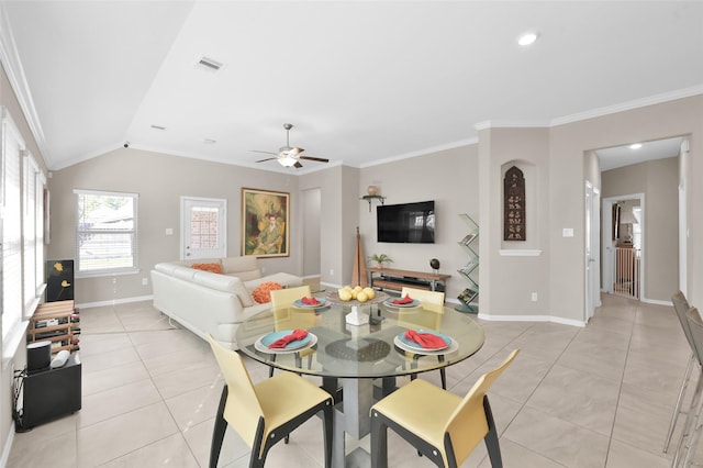 tiled dining room with ornamental molding, lofted ceiling, and ceiling fan