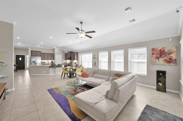 living room featuring light tile patterned flooring, ceiling fan, a healthy amount of sunlight, and vaulted ceiling