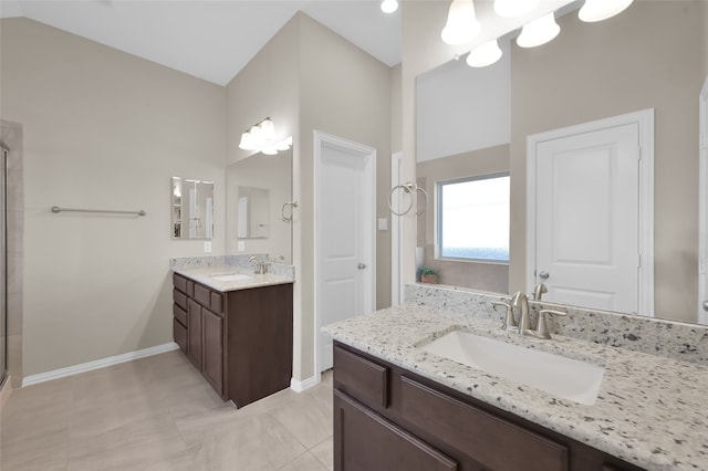 bathroom featuring tile patterned floors, vanity, and walk in shower