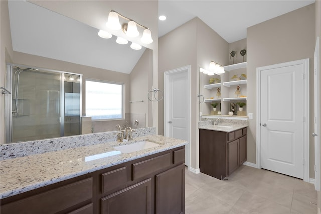 bathroom featuring vanity, tile patterned flooring, a shower with shower door, and lofted ceiling