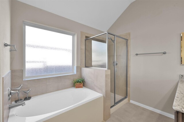 bathroom featuring separate shower and tub, tile patterned floors, vanity, and vaulted ceiling