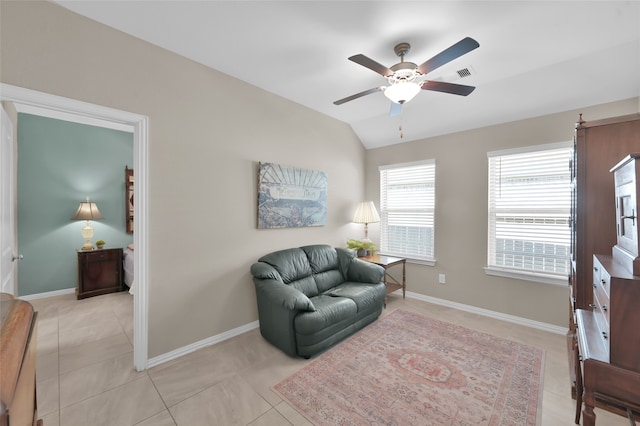 living area with light tile patterned floors, ceiling fan, and lofted ceiling