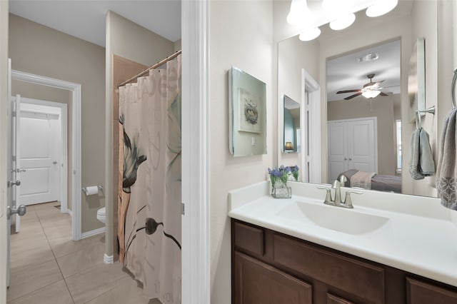 bathroom featuring tile patterned flooring, vanity, ceiling fan, and toilet