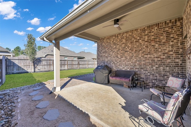 view of patio with area for grilling and ceiling fan