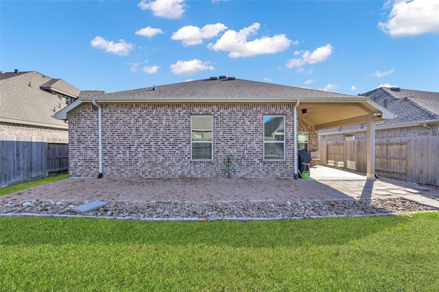 rear view of house with a yard and a patio