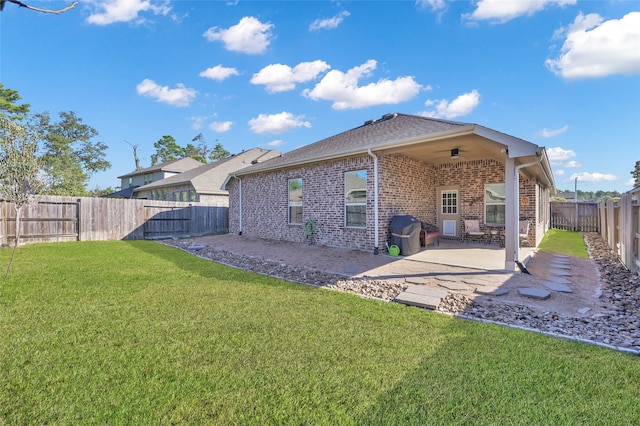 rear view of house featuring a lawn, a patio area, and ceiling fan