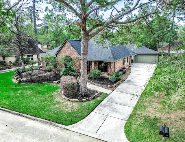 view of front of property featuring a garage and a front lawn