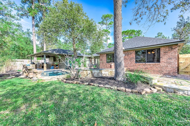 back of house with a patio area and a lawn