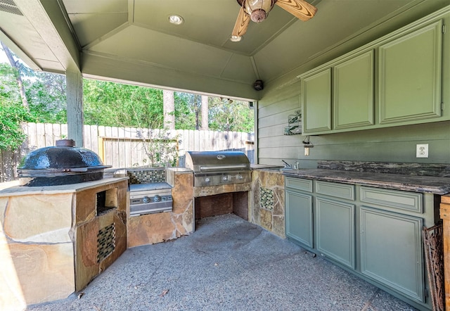 view of patio / terrace with ceiling fan, grilling area, and exterior kitchen