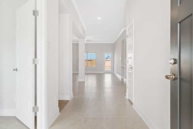 hallway featuring light tile patterned floors and ornamental molding