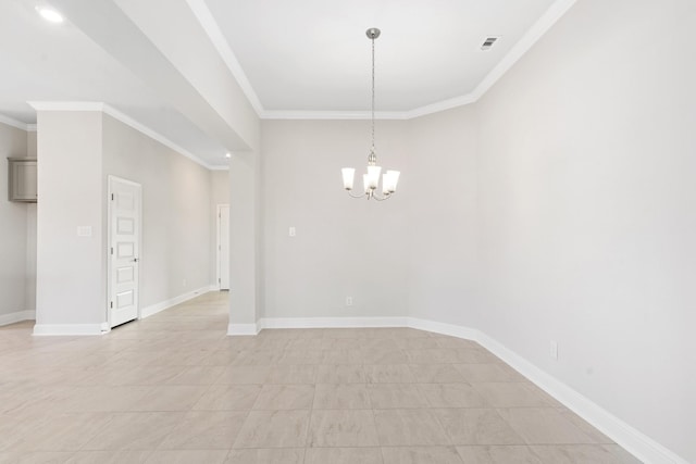 spare room featuring ornamental molding and an inviting chandelier