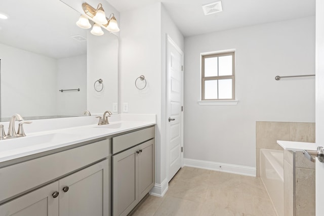 bathroom with vanity, tile patterned floors, and a bathtub