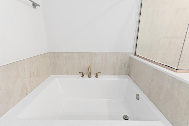 bathroom with a tub to relax in