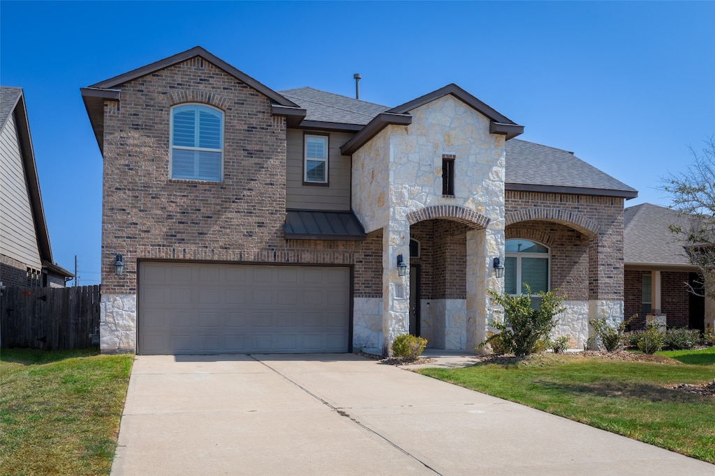 view of front of home featuring a front yard and a garage