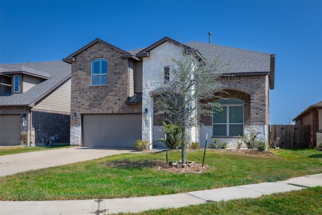 view of front of home with a front yard and a garage