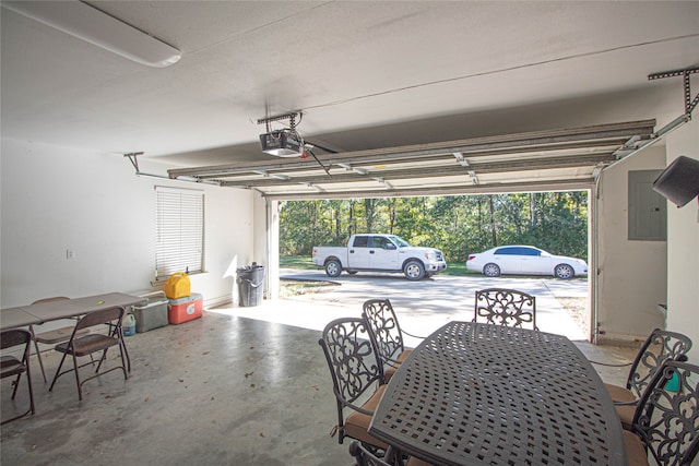 garage featuring electric panel and a garage door opener