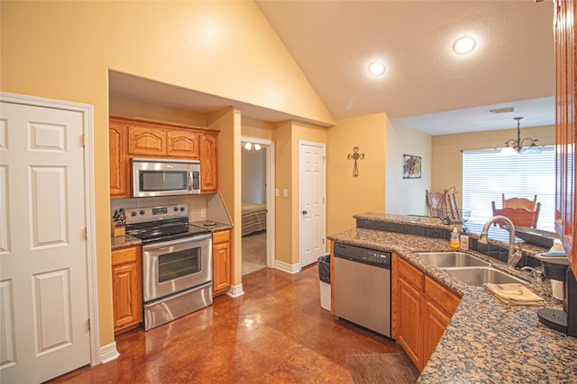 kitchen featuring high vaulted ceiling, sink, decorative light fixtures, appliances with stainless steel finishes, and a notable chandelier