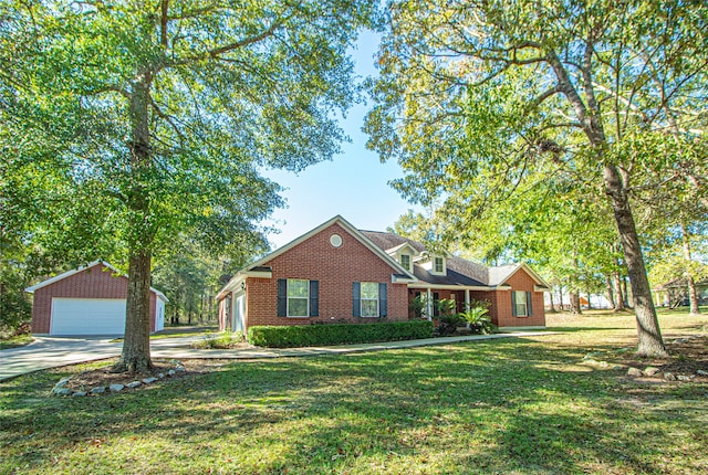 view of front facade with a front yard, a garage, and an outdoor structure