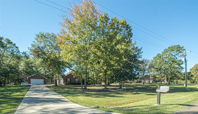 view of front of house featuring a garage, an outdoor structure, and a front lawn