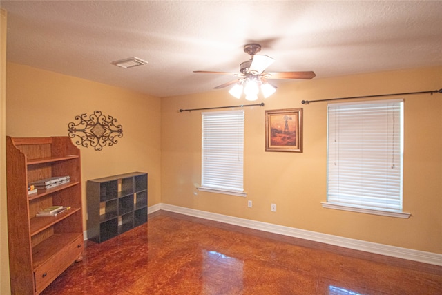 spare room with a textured ceiling and ceiling fan