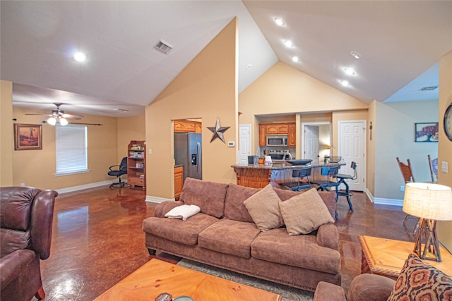 living room with ceiling fan and high vaulted ceiling