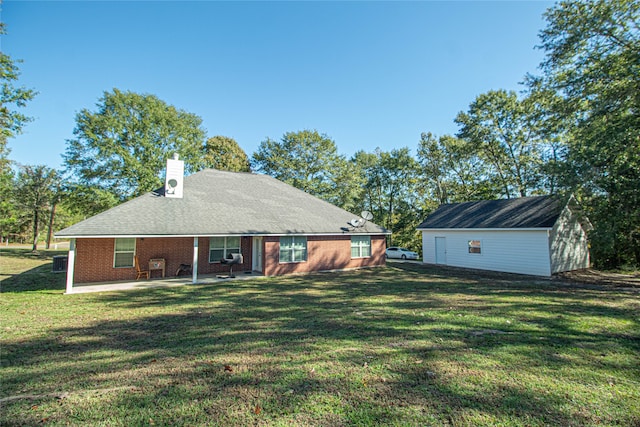 back of property with a yard and a patio