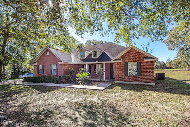 view of front of property with a front yard and central AC unit