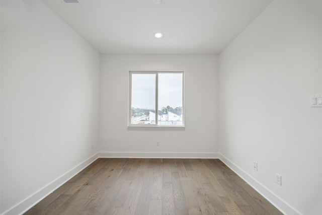 spare room with wood-type flooring